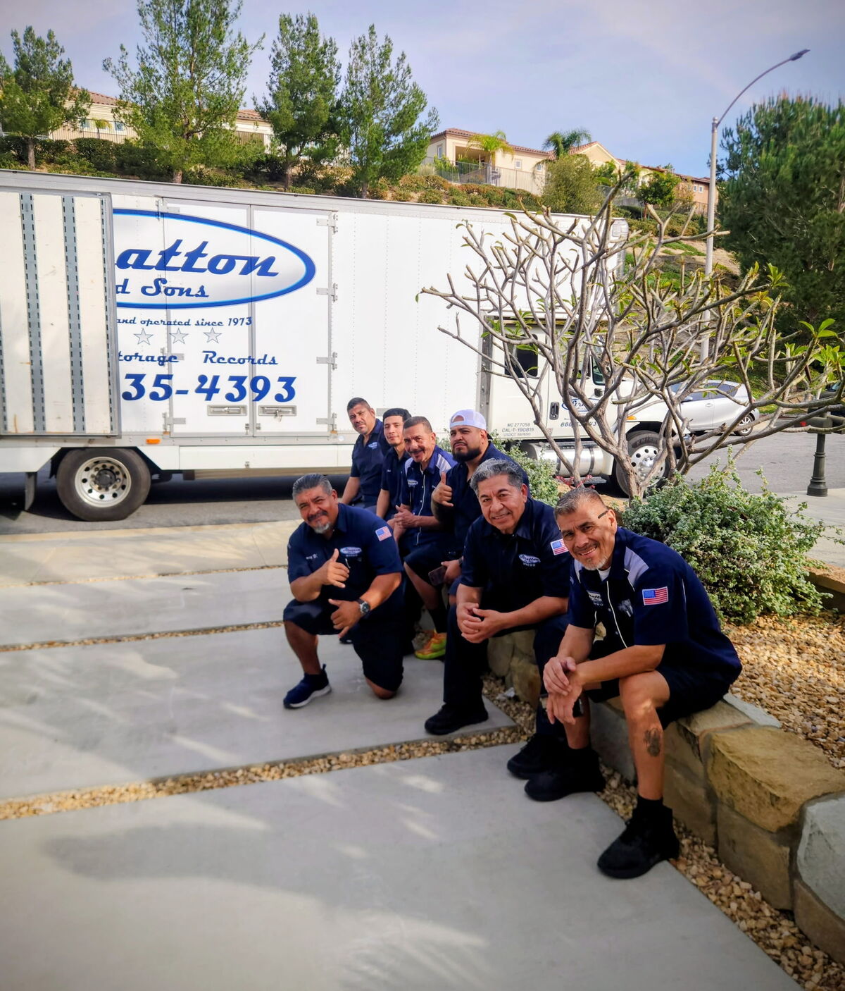 Stratton and Sons moving crew posing in front of a branded moving truck on a residential job in Porter Ranch, California