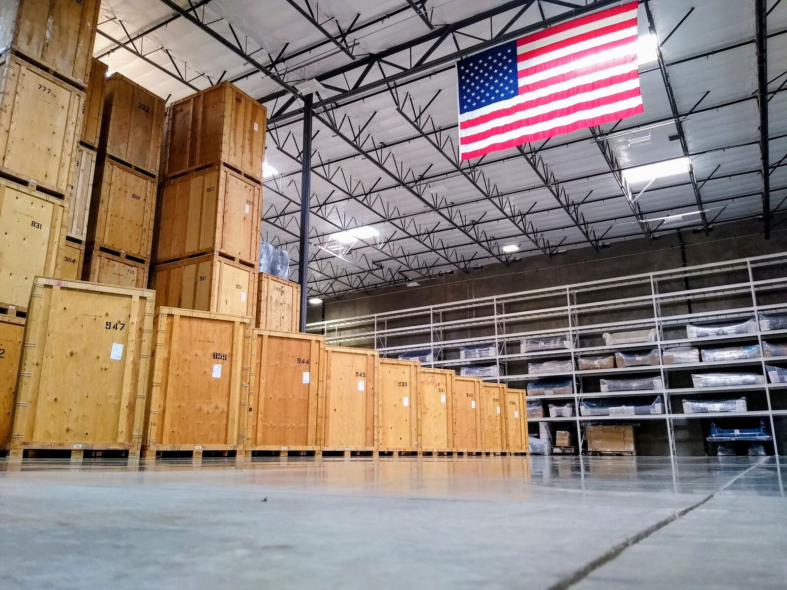 Stratton and Sons storage warehouse with numbered wooden vaults and American flag
